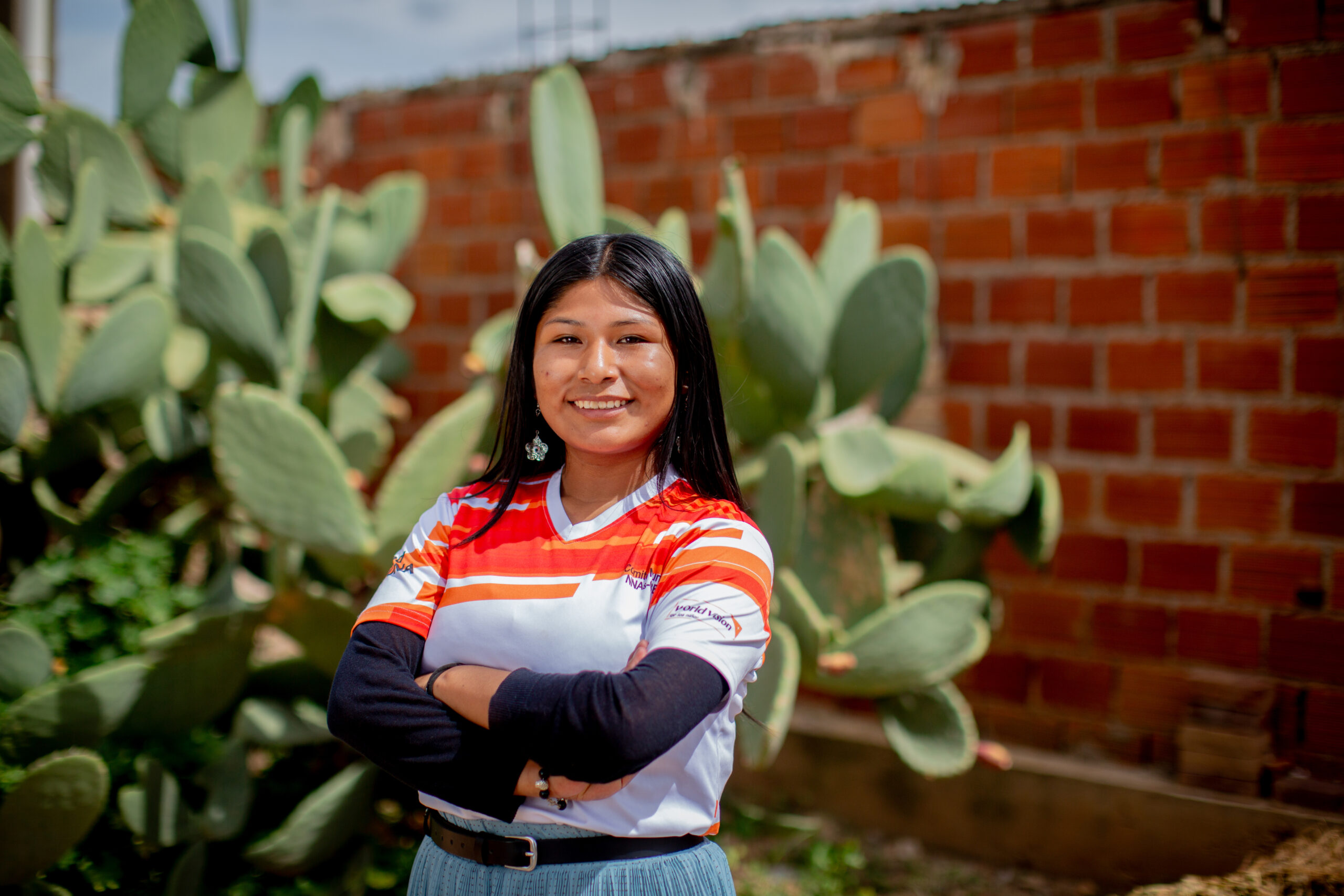 Nadeyli from Bolivia smiles and stands confidently